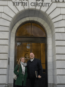 a woman and man standing in front of courtroom door